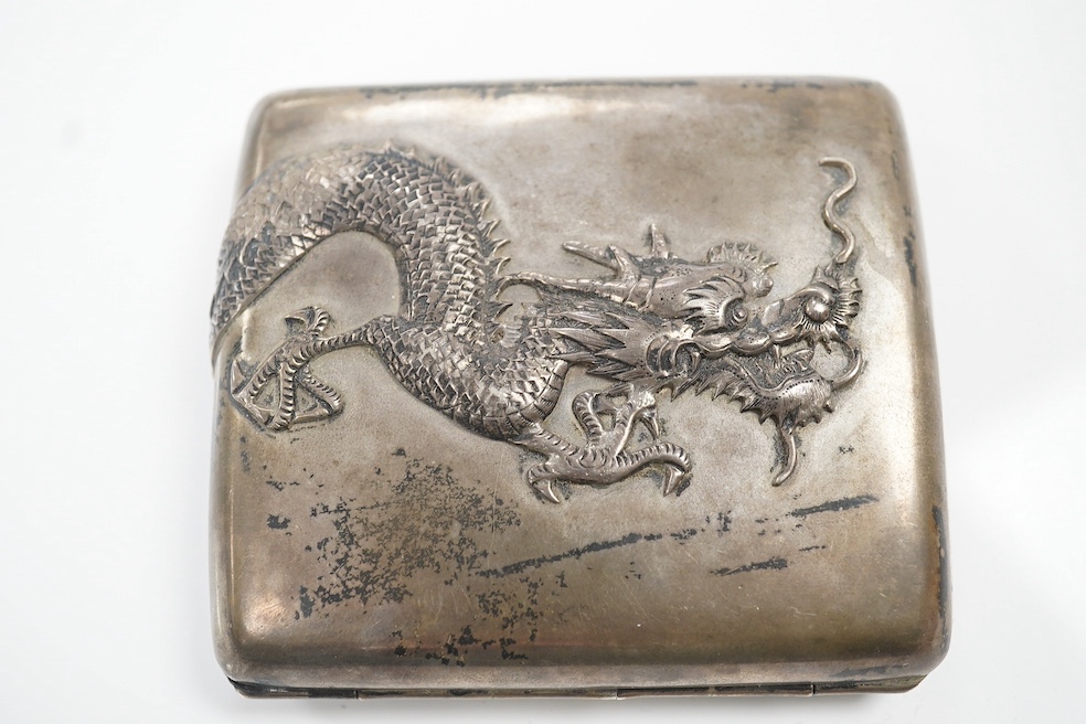 An early 20th century Chinese Export white metal cigarette case, by Sing Fat, with applied dragon decoration, 80mm, 3.8oz. Condition - fair